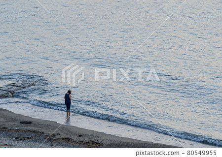 Scenery of the beach Murakami City, Niigata Prefecture, a woman looking at the sea Scenery of the beach Murakami City, Niigata Prefecture, a woman looking at the sea 80549955