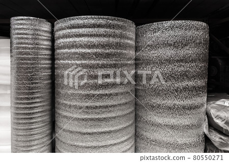 Silver rolls of insulation material, building materials in a hardware store Silver rolls of insulation material, building materials in a hardware store 80550271
