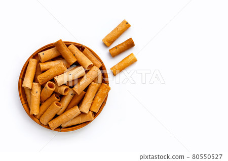 Thai crispy coconut rolls in bamboo basket on white background. Thai crispy coconut rolls in bamboo basket on white background. 80550527