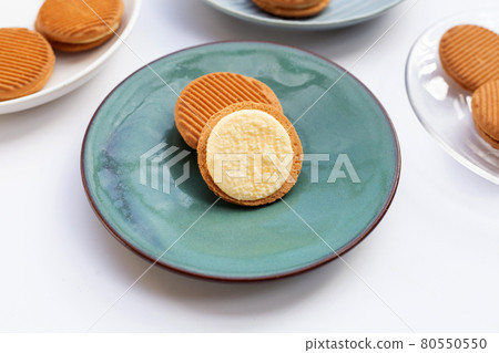 Custard cream sandwich biscuits in plate on white background. Custard cream sandwich biscuits in plate on white background. 80550550