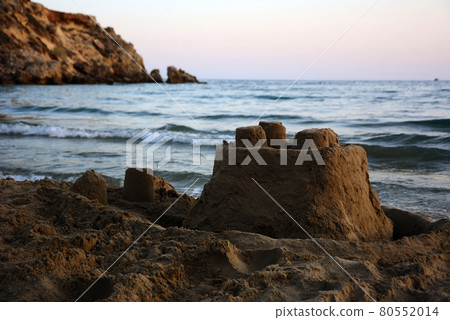 Sandcastle on the seashore in the evening. Sandcastle on the seashore in the evening. 80552014