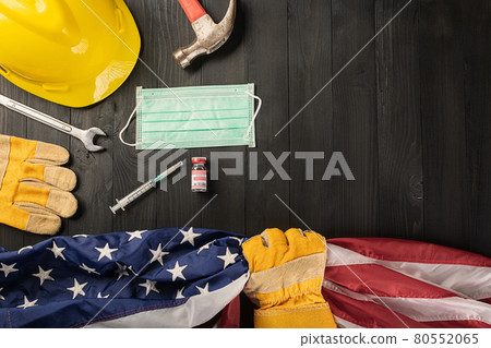 Happy Labor Day during breakout coronavirus. glove holding gripping US American flag 80552065