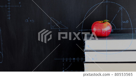 Apple on top of a pile of books and mathematical equations and graphs 80553565