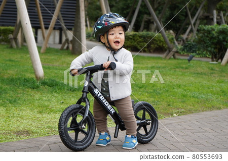 Children running on a bicycle 80553693