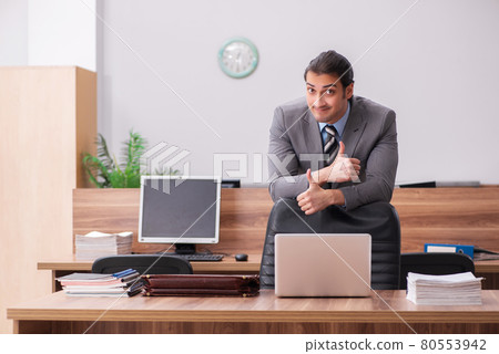 Young male employee working in the office Young male employee working in the office 80553942