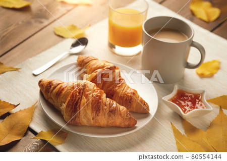 breakfast with cup of coffee, croissants, jam, fresh orange juice  80554144