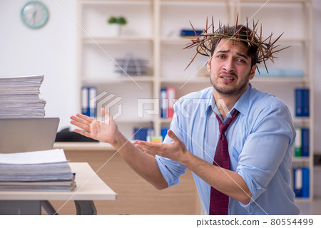 Young male employee wearing prickly wreath on head 80554499