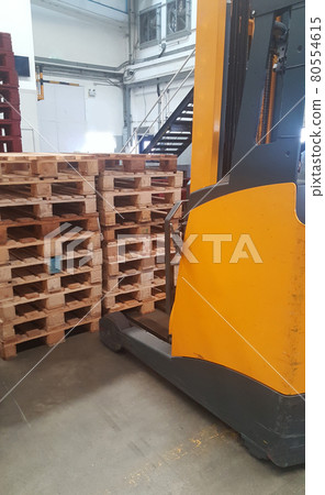 Forklift leg in front of pallet stacking in the loading warehouse dock, helpful electrical machine, supporting carry, No working due to COVID situation Forklift leg in front of pallet stacking in the loading warehouse dock, helpful electrical machine, supporting carry, No working due to COVID situation 80554615
