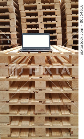 white screen laptop monitor for warehouse staff on stacking wooden pallet, isolate working condition, work from home, COVID, backgrounds 80554616