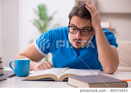 Young male student studying at home Young male student studying at home 80555641