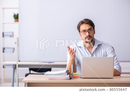 Young male teacher in telestudying concept 80555647