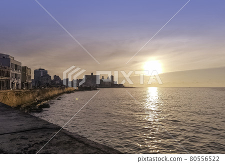 Sunset over Malecon and Atlantic Ocean with visible sun rays - Havana, Cuba  80556522