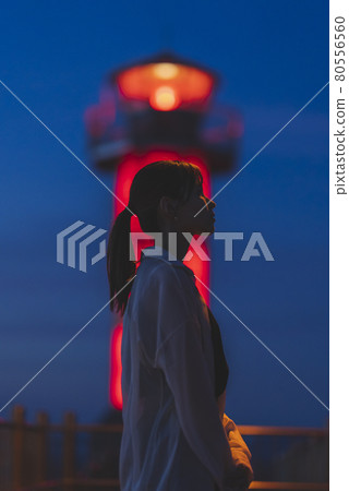 Woman in the sea at sunset Woman in the sea at sunset 80556560