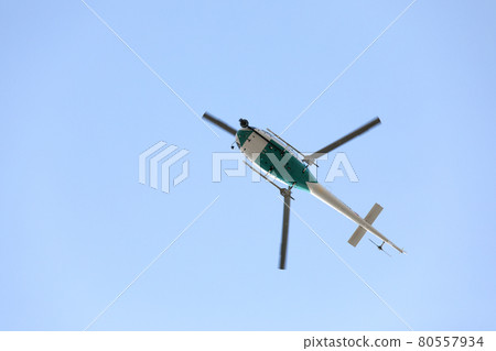 Helicopter with video surveillance system flying in blue sky 80557934