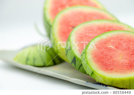 Small watermelons sliced and lined up Small watermelons sliced and lined up 80558449