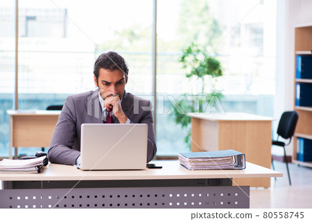 Young male employee working in the office Young male employee working in the office 80558745