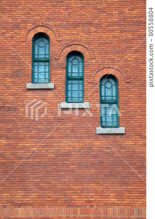 red brick wall round arch windows with stone traditional gothic background 80558804