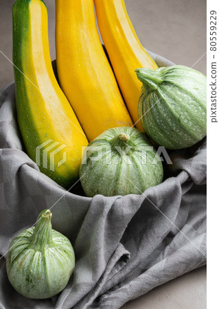 Long yellow zucchini and green round zucchini 80559229