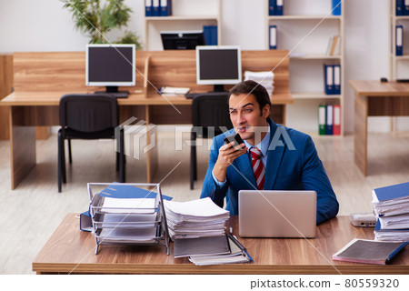 Young male employee working in the office Young male employee working in the office 80559320