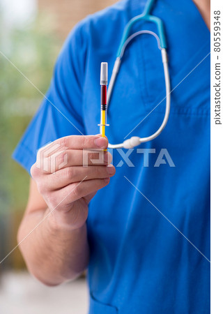 Young male doctor in vaccination concept during pandemic Young male doctor in vaccination concept during pandemic 80559348