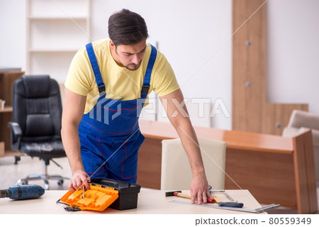 Young male carpenter working in the office 80559349