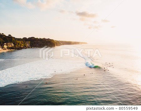 Aerial view of ocean with waves, surfers and evening light. Drone view in Bali 80559549
