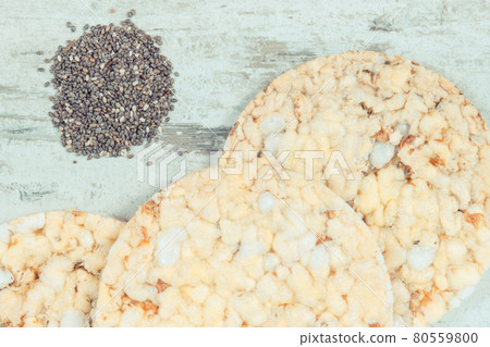 Puffed rice or corn waffles on old rustic board, healthy nutrition concept Puffed rice or corn waffles on old rustic board, healthy nutrition concept 80559800