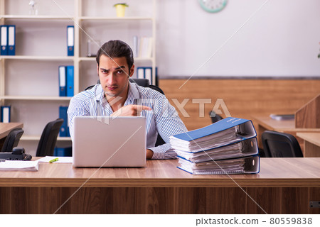 Young male employee working in the office Young male employee working in the office 80559838