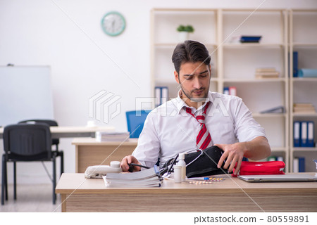 Young male employee suffering at workplace Young male employee suffering at workplace 80559891