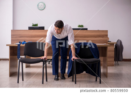 Young businessman employee doing sport exercises at workplace 80559930