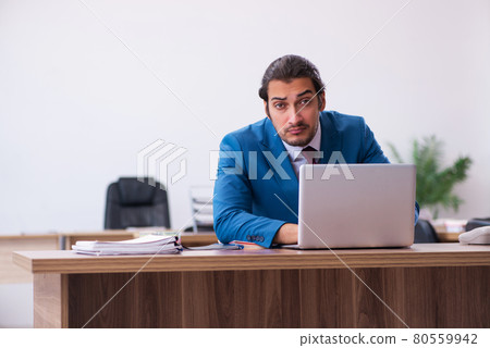 Young male employee working at workplace Young male employee working at workplace 80559942