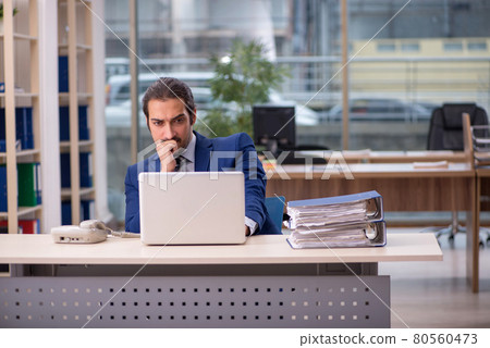 Young male employee working in the office Young male employee working in the office 80560473