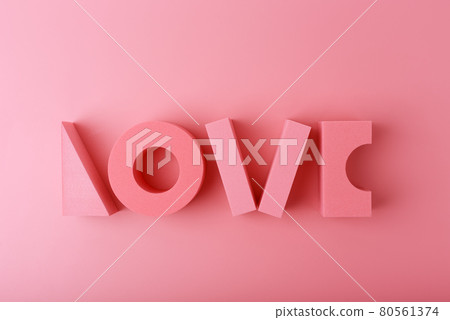 Creative flat lay with word love made of pink geometric figures against light pink background.  80561374