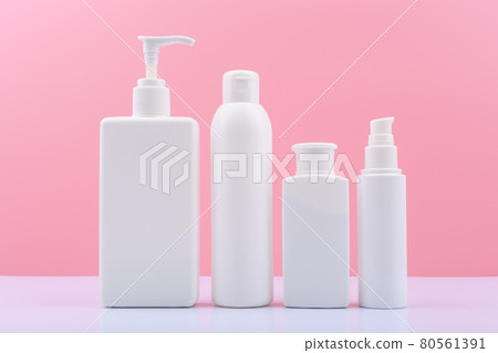 Set of beauty products for face and body skin on white table against bright pink background 80561391