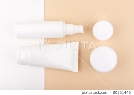 Flat lay with set of beauty products for daily skin care on white and beige background Flat lay with set of beauty products for daily skin care on white and beige background 80561446