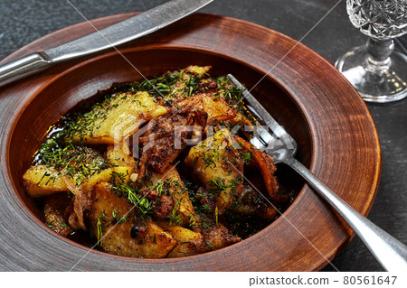 Roasted potatoes with meat, onions and dill in clay plate Roasted potatoes with meat, onions and dill in clay plate 80561647