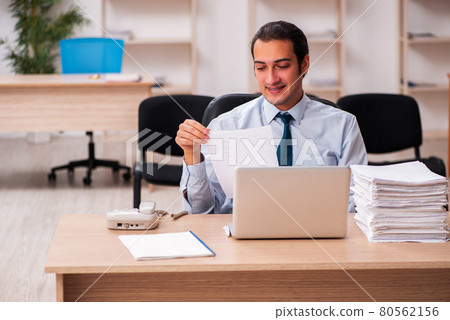 Young male employee unhappy with excessive work Young male employee unhappy with excessive work 80562156