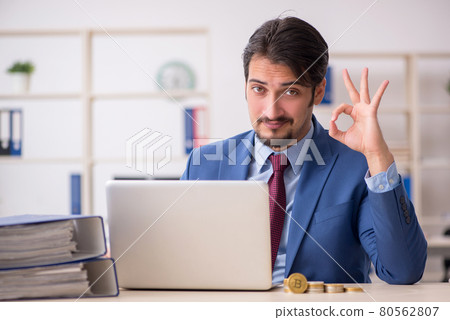 Young man earning money via Internet in cryptocurrency concept Young man earning money via Internet in cryptocurrency concept 80562807