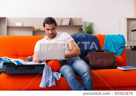 Young man student preparing for trip at home 80562874