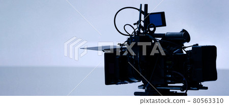 Video production behind the scenes. Making of TV commercial movie that film crew team lightman and cameraman working together with film director in studio. film production concept. Silhouette style. Video production behind the scenes. Making of TV commercial movie that film crew team lightman and cameraman working together with film director in studio. film production concept. Silhouette style. 80563310