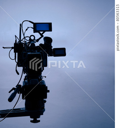 Video production behind the scenes. Making of TV commercial movie that film crew team lightman and cameraman working together with film director in studio. film production concept. Silhouette style. 80563315