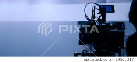 Video production behind the scenes. Making of TV commercial movie that film crew team lightman and cameraman working together with film director in studio. film production concept. Silhouette style. 80563317