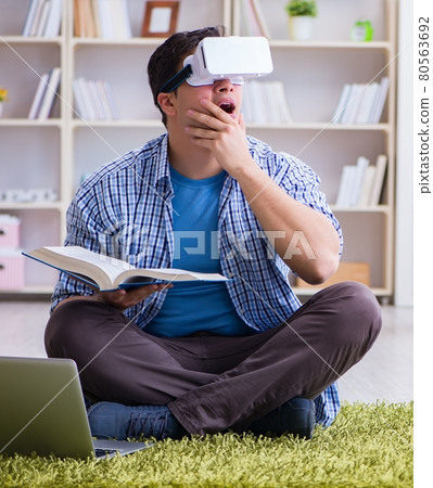Freelance student with virtual reality glasses at home Freelance student with virtual reality glasses at home 80563692