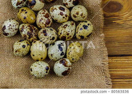 Quail eggs on a wooden table. Top view Quail eggs on a wooden table. Top view 80563836
