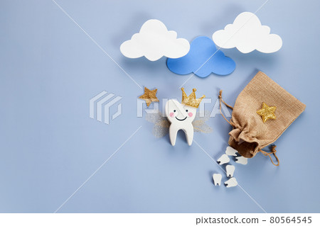 National Tooth Fairy Day. Children tooth fairy. Cute tooth with wings, a crown and a magic wand and bag with teeth. 80564545