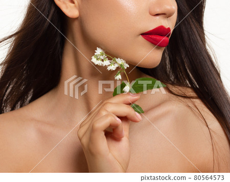 Cosmetics, makeup and trends. Bright lip gloss and lipstick on lips. Closeup of beautiful female mouth with pink lip makeup. Beautiful part of female face. Perfect clean skin in red light 80564573