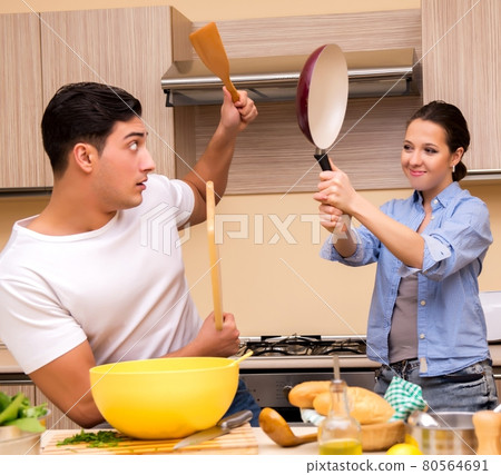 Young family doing funny fight at kitchen Young family doing funny fight at kitchen 80564691