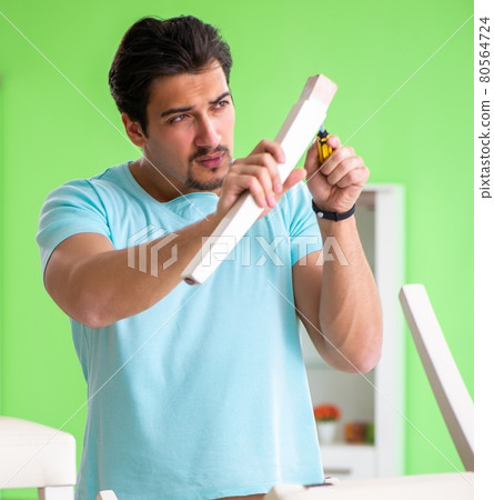 Man repairing furniture at home Man repairing furniture at home 80564724