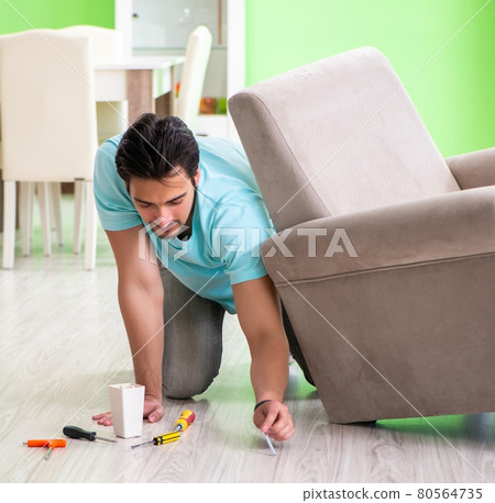 Man repairing furniture at home Man repairing furniture at home 80564735