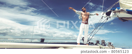 Young man sailing his boat on the open ocean Young man sailing his boat on the open ocean 80565123